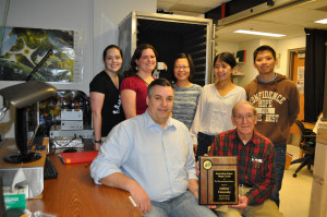 Indiana University Student Chapter officers and advisors proudly holding their award plaque. 