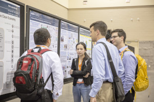 Meeting attendees discussing the research presented at the Student Poster Session.